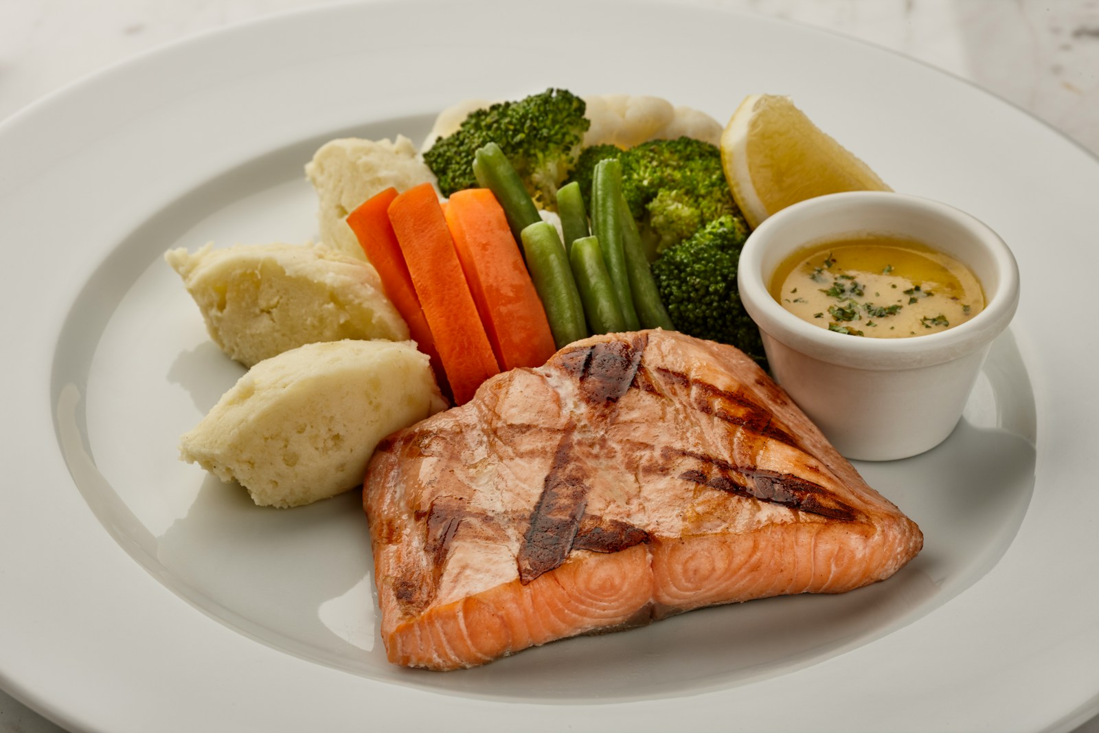 a white plate topped with meat and vegetables